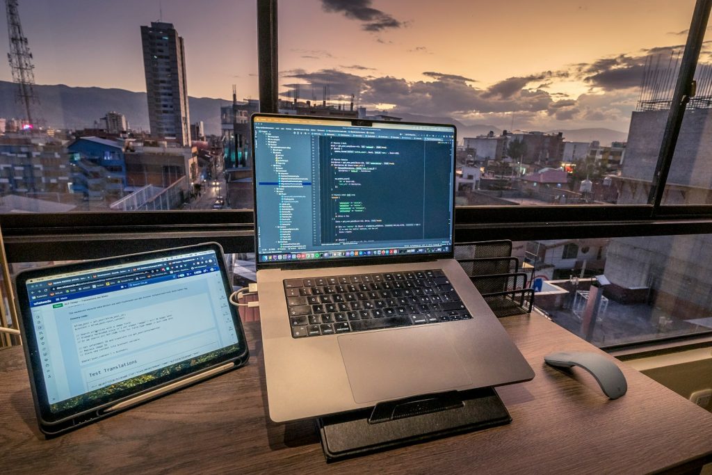 a laptop computer sitting on top of a wooden desk